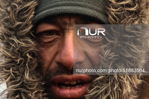 A Kashmiri wears warm clothing on a cold winter morning in Srinagar, Jammu and Kashmir, India, on December 20, 2024. 