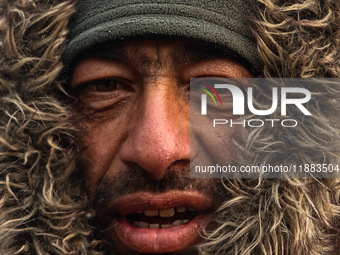 A Kashmiri wears warm clothing on a cold winter morning in Srinagar, Jammu and Kashmir, India, on December 20, 2024. (