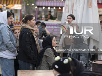 Iranian women visit the Abasabad tourism zone in central Tehran, Iran, on December 19, 2024. (