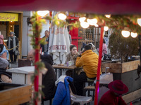 Iranian youths sit together at an outdoor fast-food restaurant while visiting the Abasabad tourism zone in central Tehran, Iran, on December...