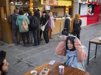 Iranian youths sit together at an outdoor fast-food restaurant while visiting the Abasabad tourism zone in central Tehran, Iran, on December...