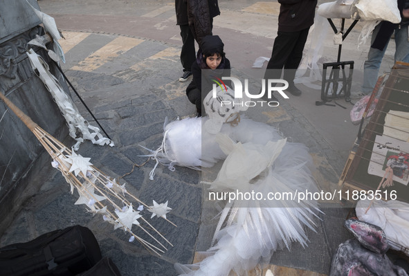 A young Iranian female puppeteer prepares to perform at a festival in the Abasabad tourism zone in central Tehran, Iran, on December 19, 202...