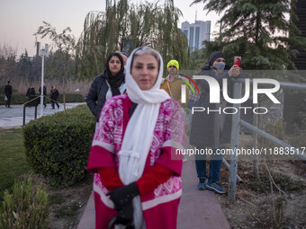 Iranian women stand together while visiting the Abasabad tourism zone during a festival in central Tehran, Iran, on December 19, 2024. (