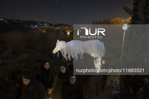 Young Iranian female puppeteers stand next to a puppet, waiting to perform at a festival in the Abasabad tourism zone in central Tehran, Ira...