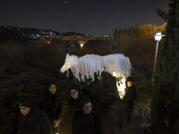 Young Iranian female puppeteers stand next to a puppet, waiting to perform at a festival in the Abasabad tourism zone in central Tehran, Ira...