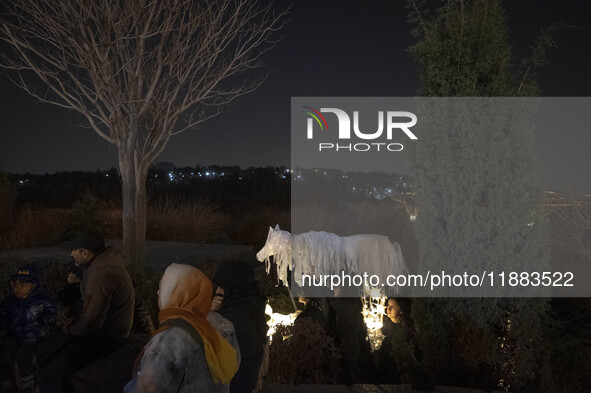 Young Iranian female puppeteers stand next to a puppet, waiting to perform at a festival in the Abasabad tourism zone in central Tehran, Ira...