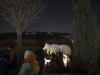 Young Iranian female puppeteers stand next to a puppet, waiting to perform at a festival in the Abasabad tourism zone in central Tehran, Ira...