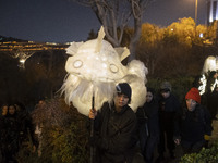 Young Iranian female puppeteers stand next to a puppet, waiting to perform at a festival in the Abasabad tourism zone in central Tehran, Ira...