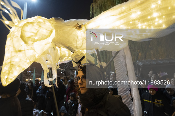 A young Iranian female puppeteer stands with her puppet and performs at a festival in the Abasabad tourism zone in central Tehran, Iran, on...