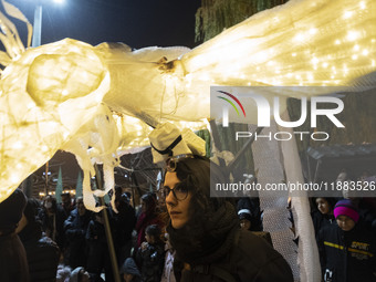 A young Iranian female puppeteer stands with her puppet and performs at a festival in the Abasabad tourism zone in central Tehran, Iran, on...