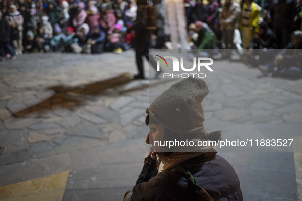 A young Iranian female artist plays music while performing at a festival in the Abasabad tourism zone in central Tehran, Iran, on December 1...