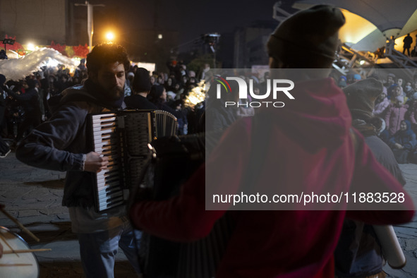 Young Iranian artists play music while performing at a festival in the Abasabad tourism zone in central Tehran, Iran, on December 19, 2024. 