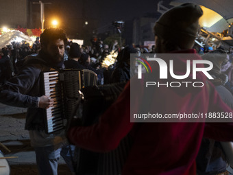 Young Iranian artists play music while performing at a festival in the Abasabad tourism zone in central Tehran, Iran, on December 19, 2024....