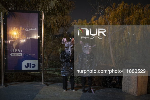 Iranian puppeteers wear mouse-shaped masks and stand together while waiting to perform at a festival in the Abasabad tourism zone in central...