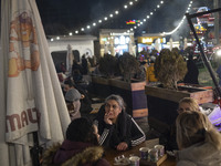 Iranian women sit together at an outdoor fast-food restaurant while visiting the Abasabad tourism zone in central Tehran, Iran, on December...