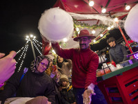 An Iranian vendor prepares a traditional sweet for his clients during a festival in the Abasabad tourism zone in central Tehran, Iran, on De...