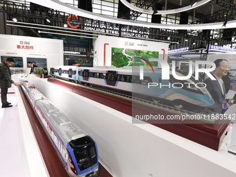 People visit a model EMU train on display at the World Intelligent Manufacturing Conference 2024 in Nanjing, China, on December 20, 2024. (