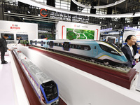 People visit a model EMU train on display at the World Intelligent Manufacturing Conference 2024 in Nanjing, China, on December 20, 2024. (