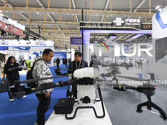 People visit a drone on display at the World Intelligent Manufacturing Conference 2024 in Nanjing, China, on December 20, 2024. (