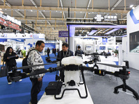 People visit a drone on display at the World Intelligent Manufacturing Conference 2024 in Nanjing, China, on December 20, 2024. (