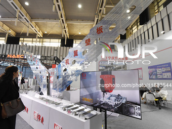 People visit a flying wing device on display at the World Intelligent Manufacturing Conference 2024 in Nanjing, China, on December 20, 2024....