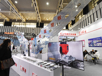 People visit a flying wing device on display at the World Intelligent Manufacturing Conference 2024 in Nanjing, China, on December 20, 2024....