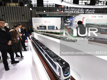 People visit a model EMU train on display at the World Intelligent Manufacturing Conference 2024 in Nanjing, China, on December 20, 2024. (