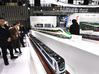 People visit a model EMU train on display at the World Intelligent Manufacturing Conference 2024 in Nanjing, China, on December 20, 2024. (