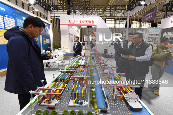 People visit a smart port installation on display at the World Smart Manufacturing Conference 2024 in Nanjing, China, on December 20, 2024. 