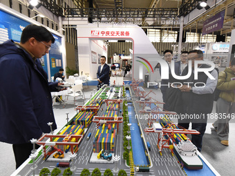 People visit a smart port installation on display at the World Smart Manufacturing Conference 2024 in Nanjing, China, on December 20, 2024....