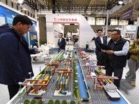 People visit a smart port installation on display at the World Smart Manufacturing Conference 2024 in Nanjing, China, on December 20, 2024....