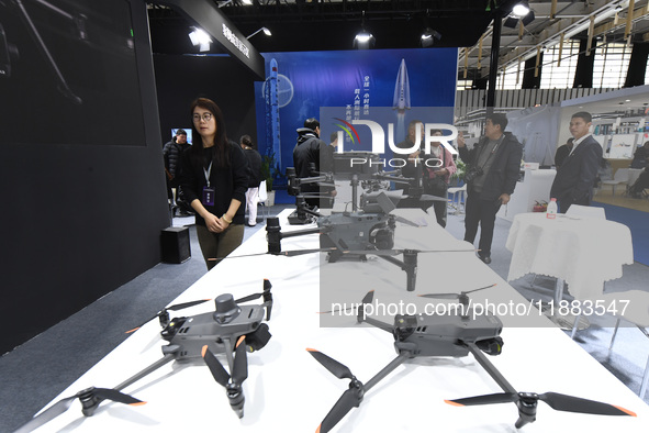 People visit a DJI drone on display at the 2024 World Intelligent Manufacturing Conference in Nanjing, China, on December 20, 2024. 