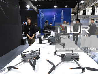 People visit a DJI drone on display at the 2024 World Intelligent Manufacturing Conference in Nanjing, China, on December 20, 2024. (