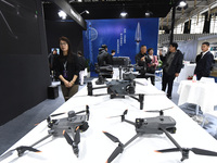 People visit a DJI drone on display at the 2024 World Intelligent Manufacturing Conference in Nanjing, China, on December 20, 2024. (