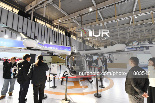 People visit a vertical drone on display at the World Intelligent Manufacturing Conference 2024 in Nanjing, China, on December 20, 2024. 