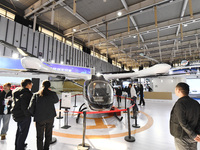 People visit a vertical drone on display at the World Intelligent Manufacturing Conference 2024 in Nanjing, China, on December 20, 2024. (