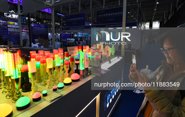 People visit smart photo lights on display at the 2024 World Intelligent Manufacturing Conference in Nanjing, China, on December 20, 2024. 