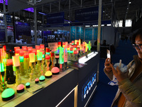 People visit smart photo lights on display at the 2024 World Intelligent Manufacturing Conference in Nanjing, China, on December 20, 2024. (