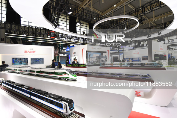 People visit a model EMU train on display at the World Intelligent Manufacturing Conference 2024 in Nanjing, China, on December 20, 2024. 