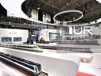 People visit a model EMU train on display at the World Intelligent Manufacturing Conference 2024 in Nanjing, China, on December 20, 2024. (