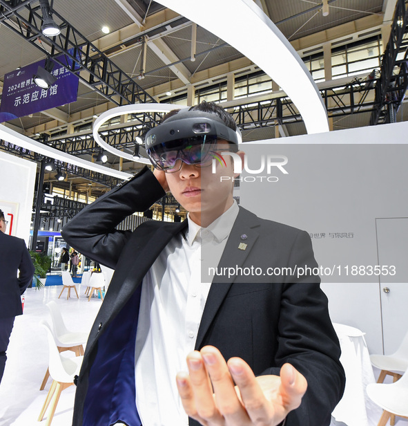 People experience Huawei intelligent equipment at the 2024 World Intelligent Manufacturing Conference in Nanjing, China, on December 20, 202...