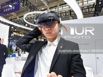 People experience Huawei intelligent equipment at the 2024 World Intelligent Manufacturing Conference in Nanjing, China, on December 20, 202...