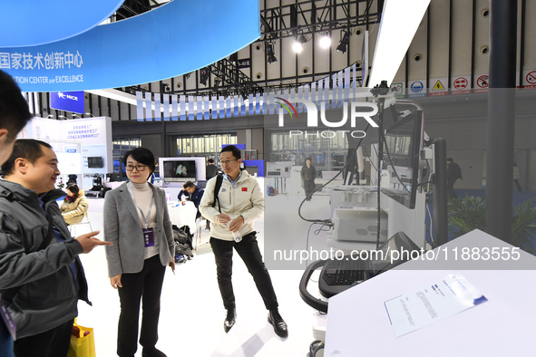 People visit and exhibit smart products at the 2024 World Intelligent Manufacturing Conference in Nanjing, China, on December 20, 2024. 