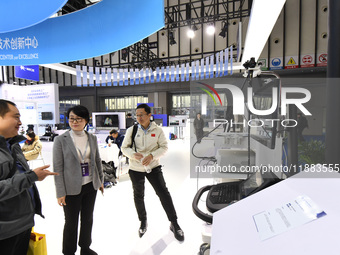 People visit and exhibit smart products at the 2024 World Intelligent Manufacturing Conference in Nanjing, China, on December 20, 2024. (