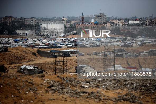 A picture shows a makeshift tent camp for displaced Palestinians in rainy weather in Khan Yunis, Gaza Strip, on December 20, 2024, amid the...