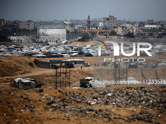 A picture shows a makeshift tent camp for displaced Palestinians in rainy weather in Khan Yunis, Gaza Strip, on December 20, 2024, amid the...