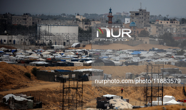 A picture shows a makeshift tent camp for displaced Palestinians in rainy weather in Khan Yunis, Gaza Strip, on December 20, 2024, amid the...