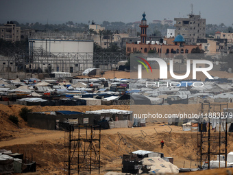 A picture shows a makeshift tent camp for displaced Palestinians in rainy weather in Khan Yunis, Gaza Strip, on December 20, 2024, amid the...