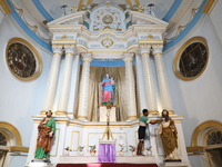 A worker cleans a statue inside a church in Kolkata, India, on December 20, 2024, ahead of Christmas celebrations. (