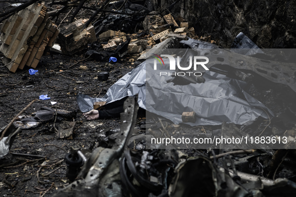 The body of a person killed by a Russian missile strike lies on the street in central Kyiv, Ukraine, on December 20, 2024. 